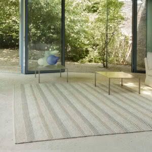 Modern living room with glass walls overlooking garden