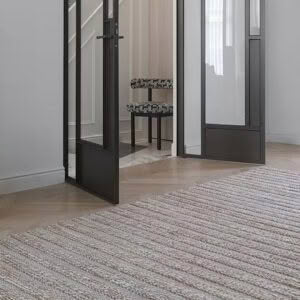 Elegant interior with mirror, chair, and textured rug