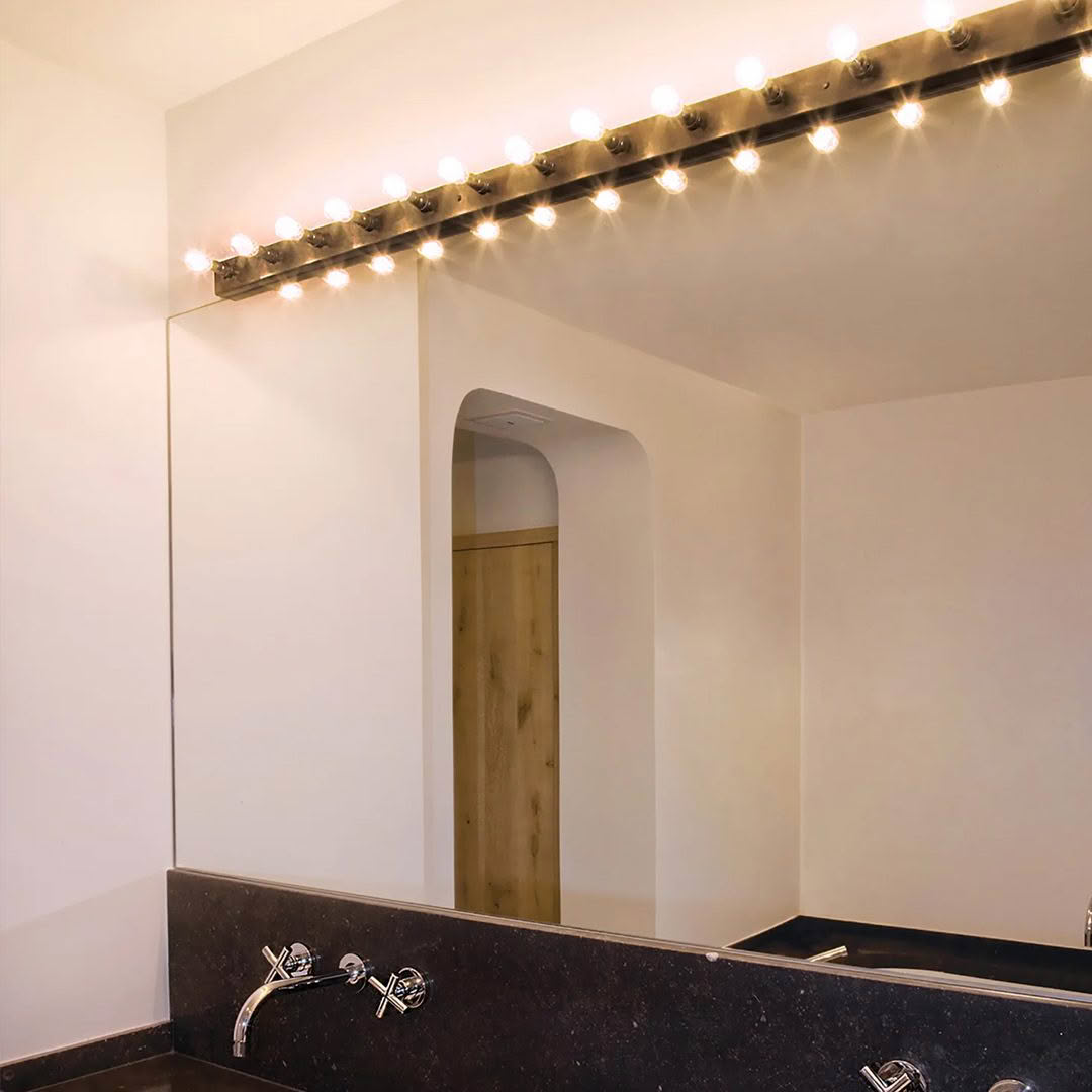 Modern bathroom with elegant lighting and wooden door