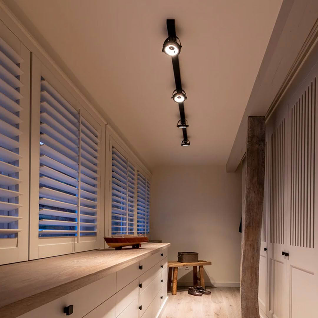 Modern interior with track lighting and plantation shutters