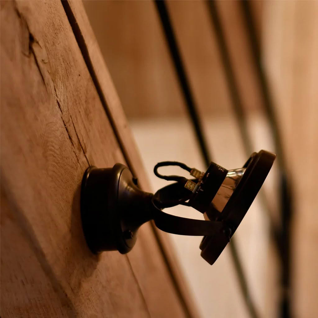 Wall-mounted vintage bell on wooden surface
