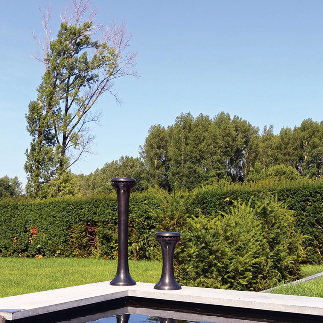 Two different sized black vases on garden platform
