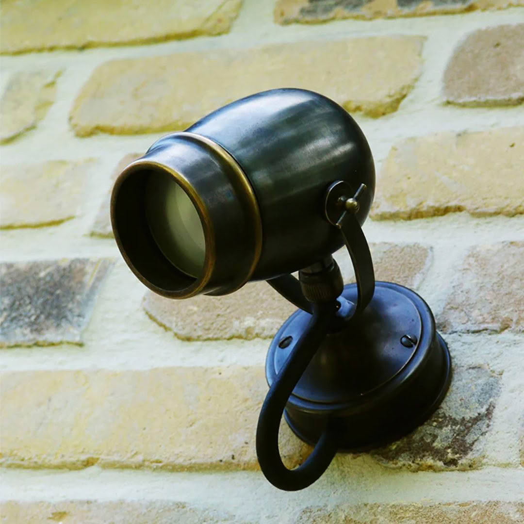 Vintage wall-mounted spotlight on stone backdrop