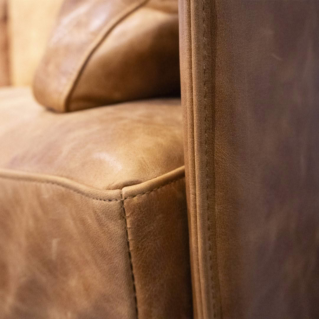 Close-up of a tan leather sofa detail
