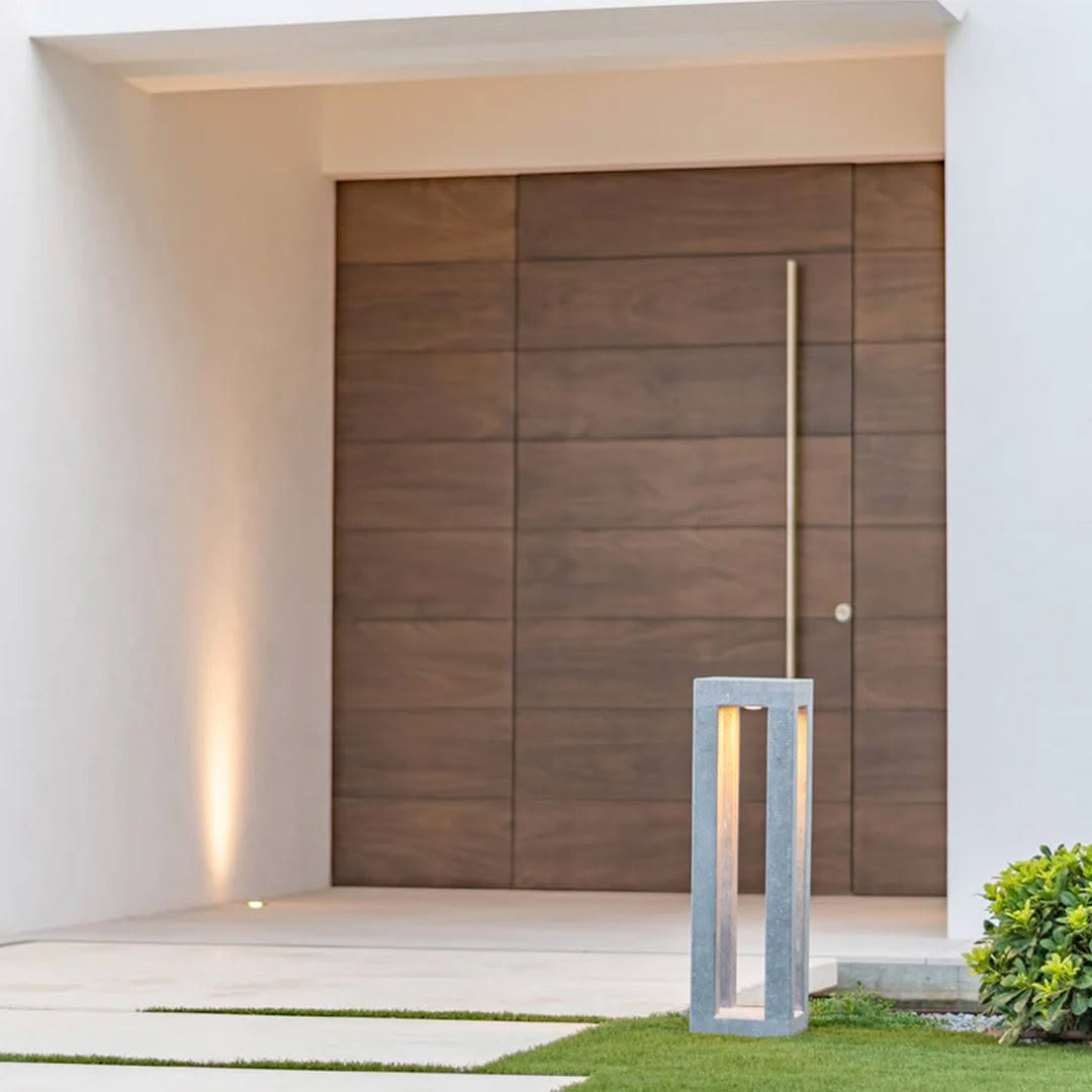 Modern home entrance with wooden door and outdoor lamp
