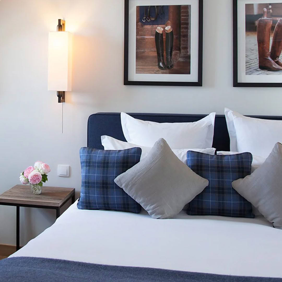 Elegant bedroom decor with plaid pillows and wall art