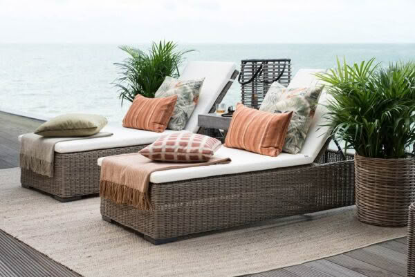 Cozy outdoor furniture on seaside deck with ocean view
