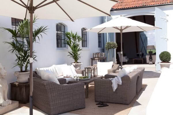 Elegant outdoor seating area with umbrella and plush seats