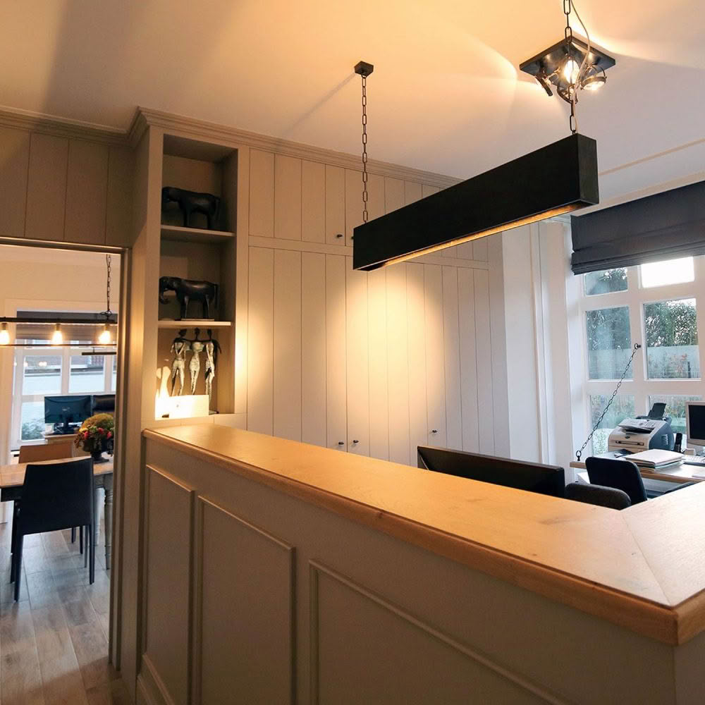 Elegant home office with modern lighting and wooden accents.