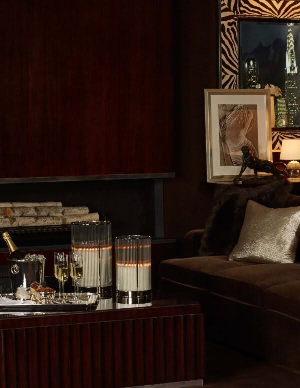 Elegant home bar setup with drinks and cozy seating