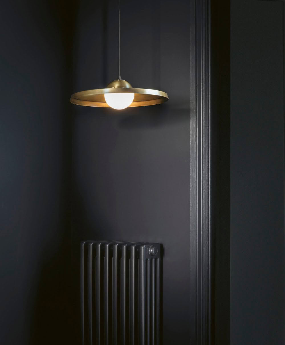 Modern hanging light in dark room with radiator