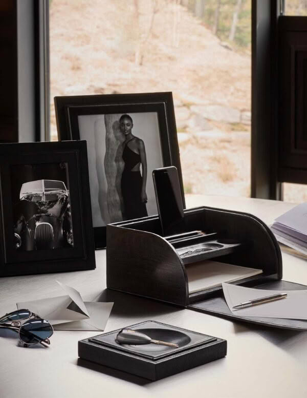 Elegant desk setup with framed photos and accessories
