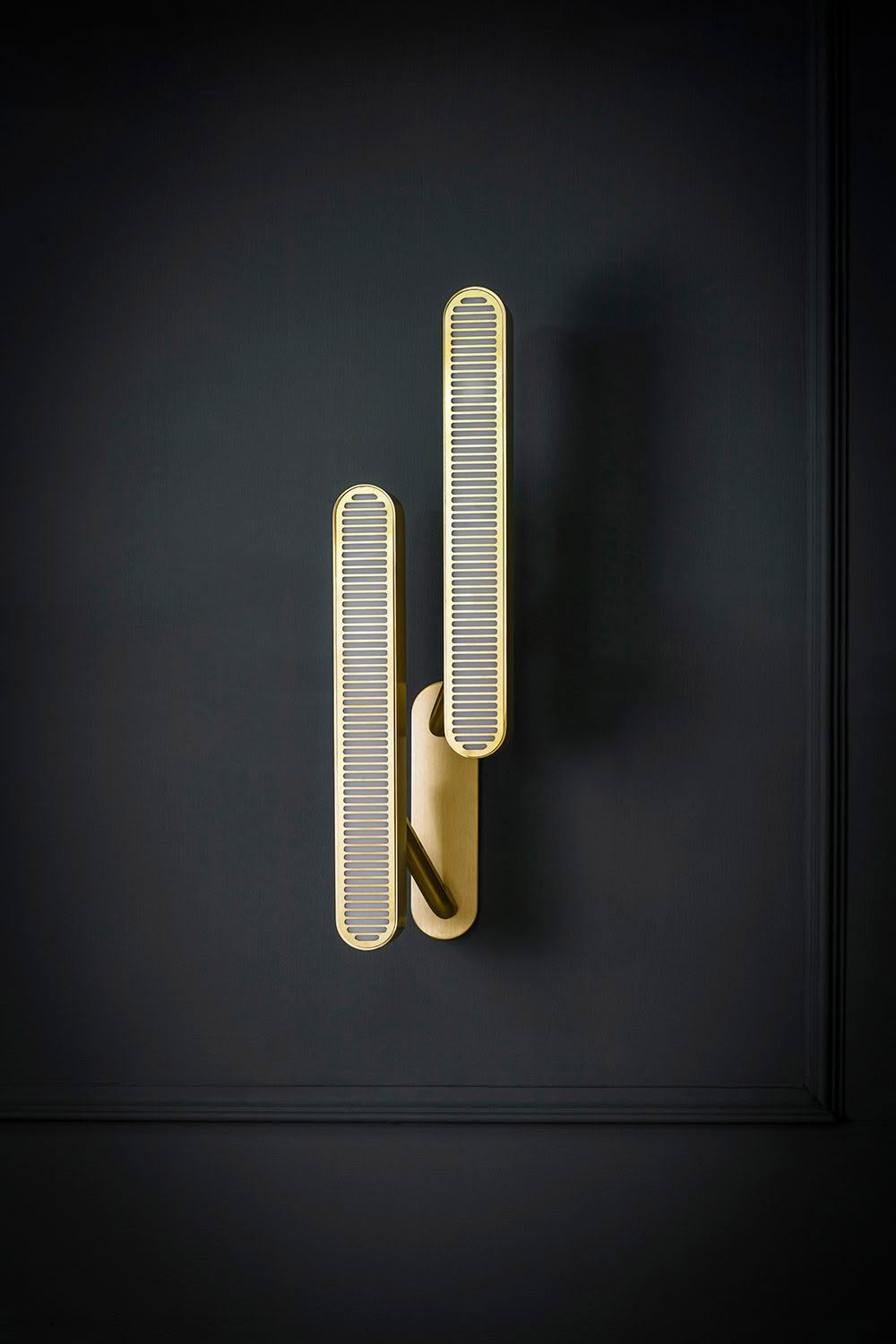 Sleek modern gold door handle on dark wall