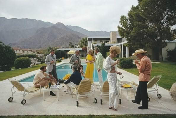 Vintage pool party with stylish guests in desert setting