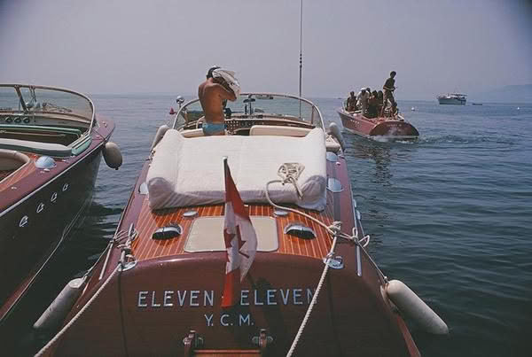 Vintage boats cruising on a foggy lake