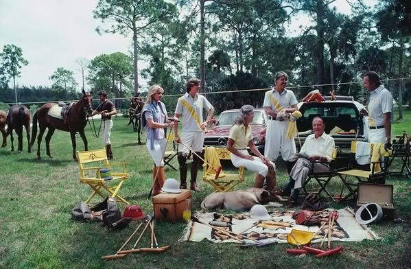 Group prepping for vintage outdoor filming, horses and gear