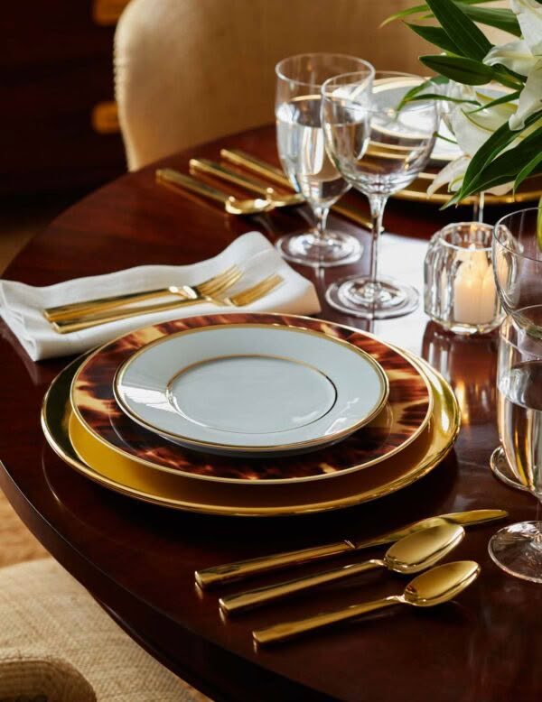 Elegant table setting with gold and tortoiseshell plates