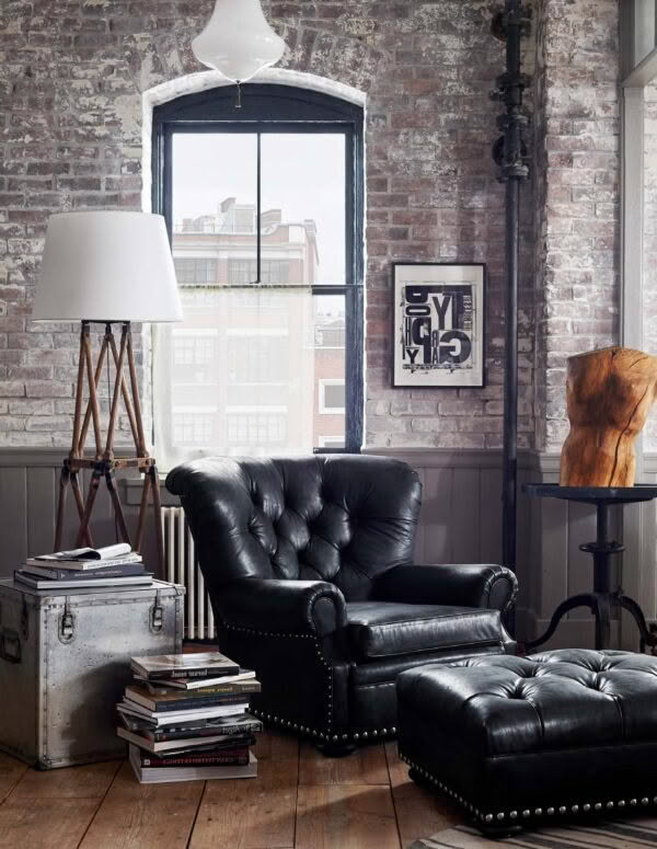 Stylish urban loft with vintage leather furniture and brick walls