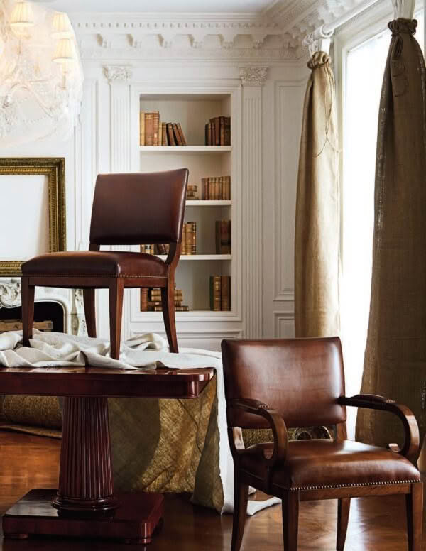 Elegant home study with leather chairs and built-in bookshelves