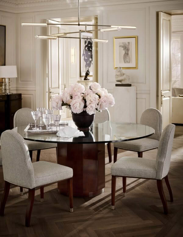 Elegant dining room with glass table and floral centerpiece