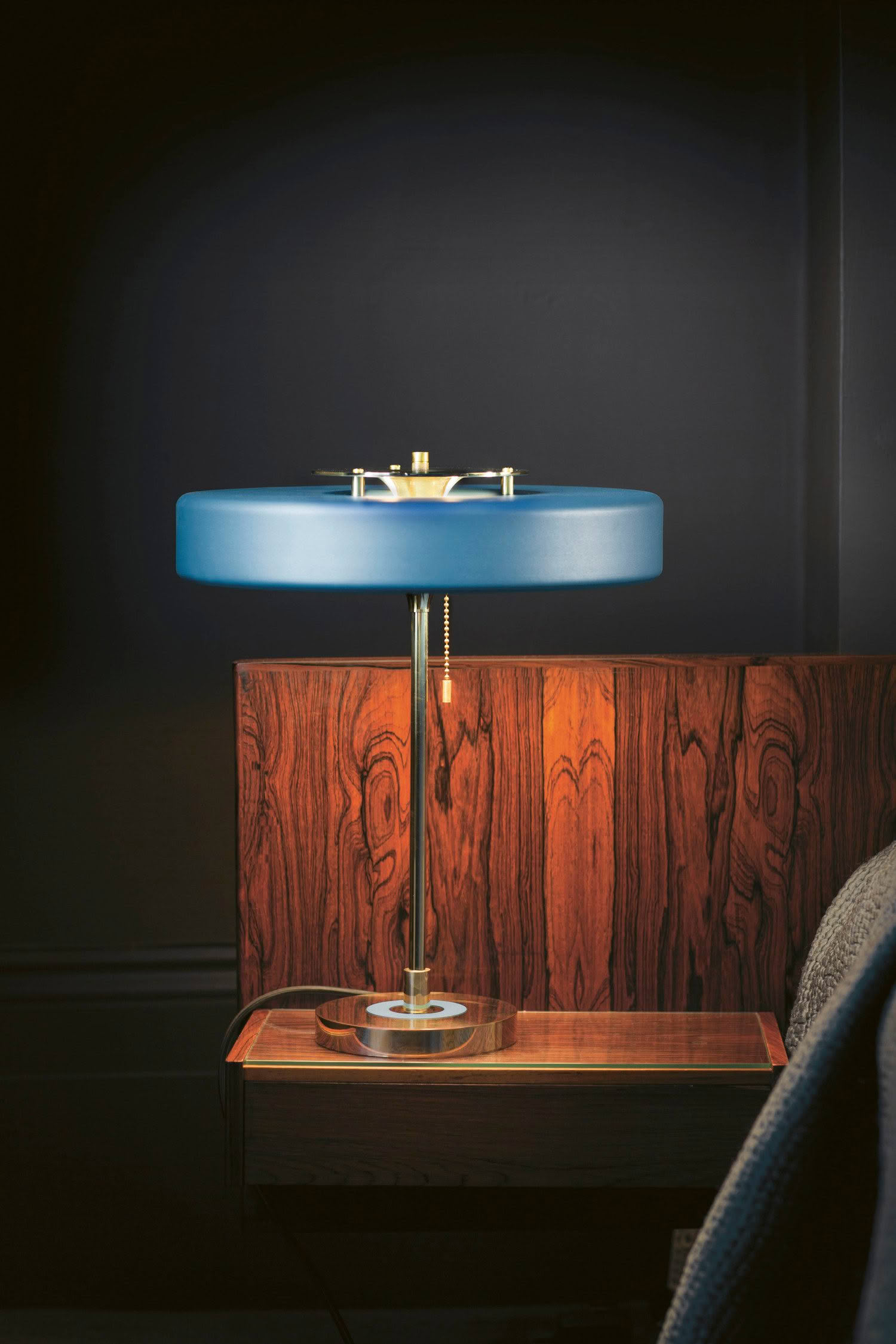 Elegant blue lamp on wooden side table