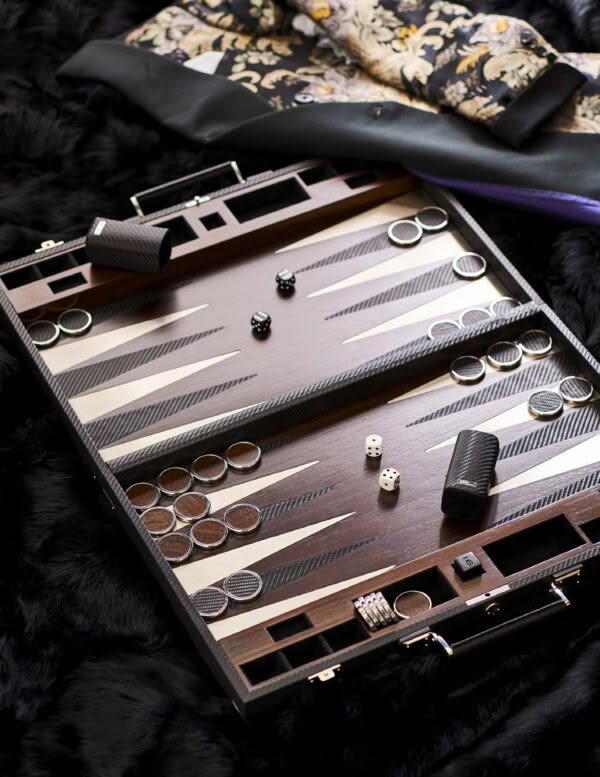 Elegant backgammon set on fur, dice, and accessories