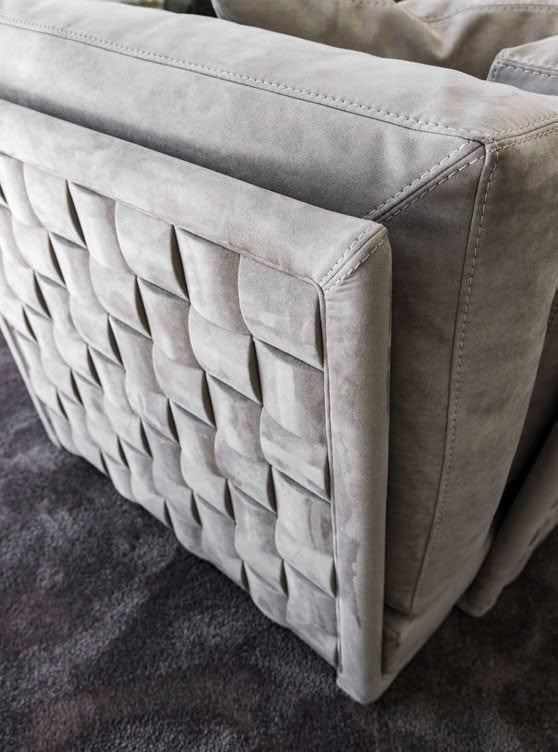 Gray tufted sofa on textured rug