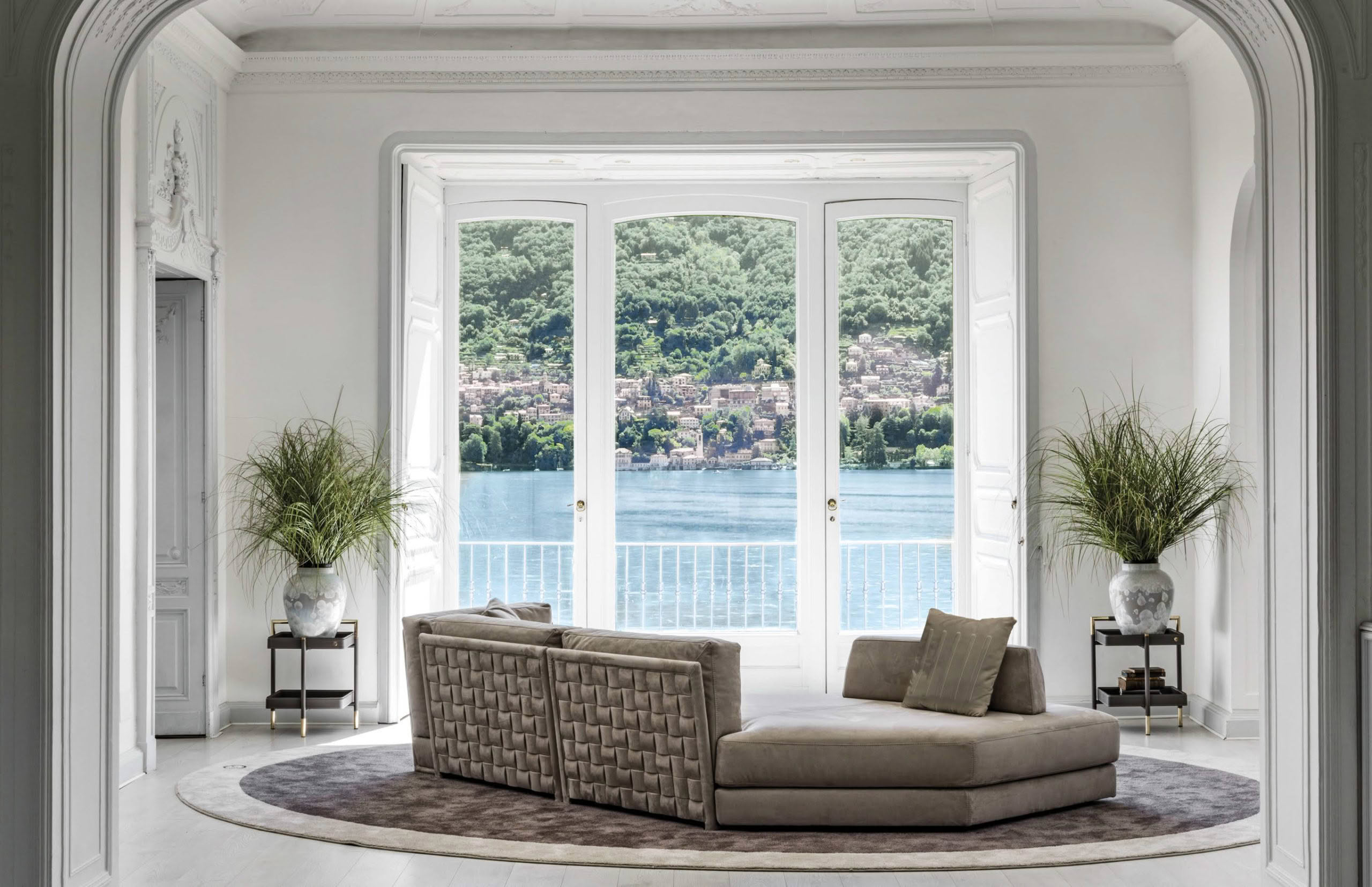 Elegant room overlooking scenic lake through large windows