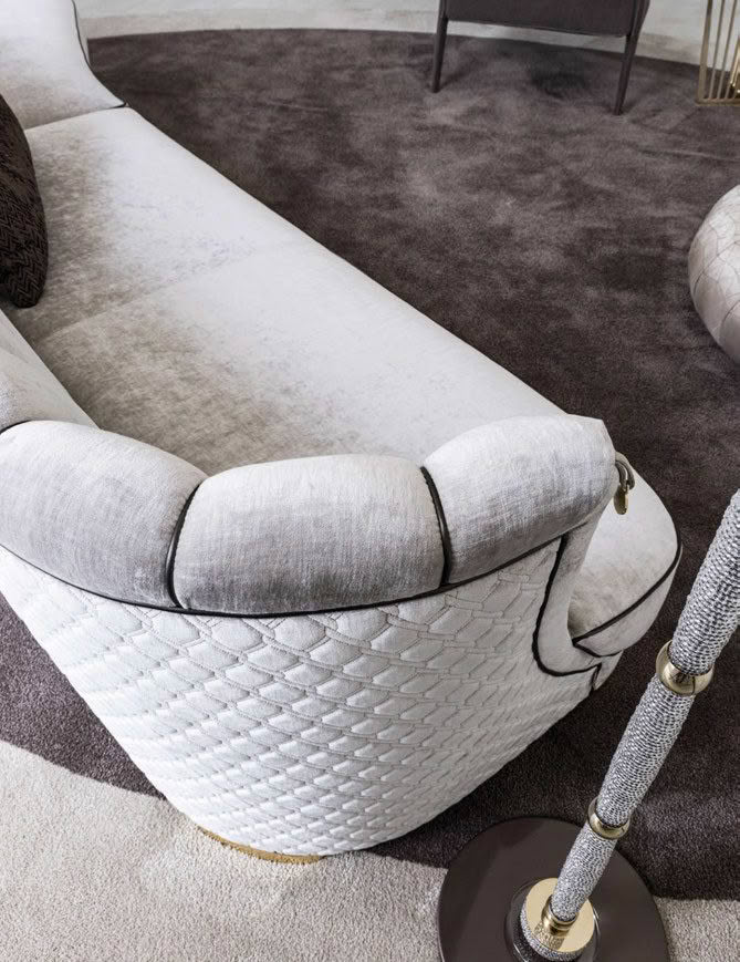 Elegant curved white sofa with quilted details