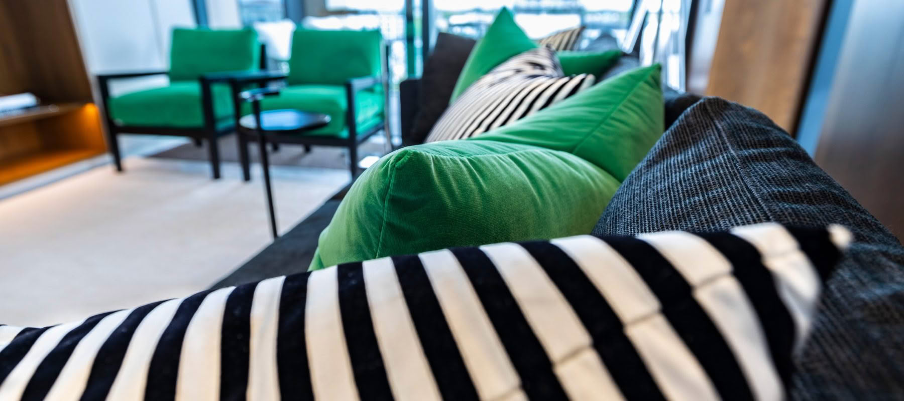 Modern living room with striped and green cushions