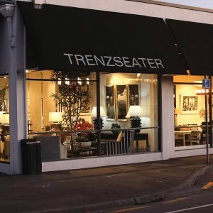 Trenzseater store exterior at dusk with lit interior