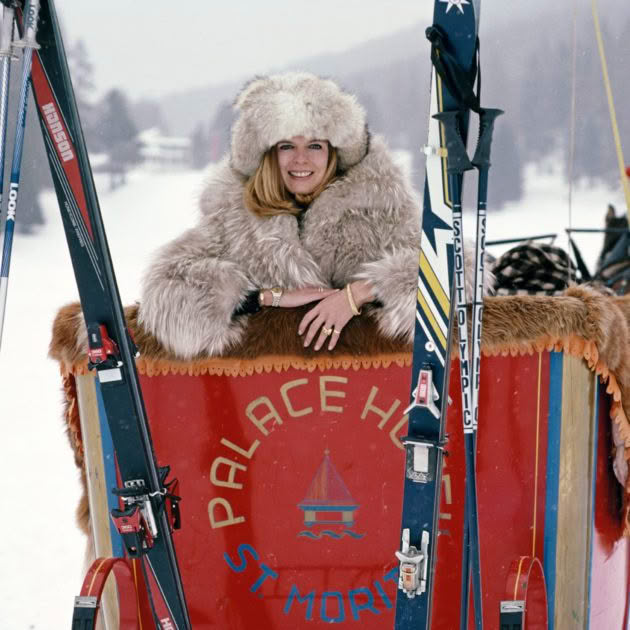 Woman in fur hat smiling in St Moritz ski sled