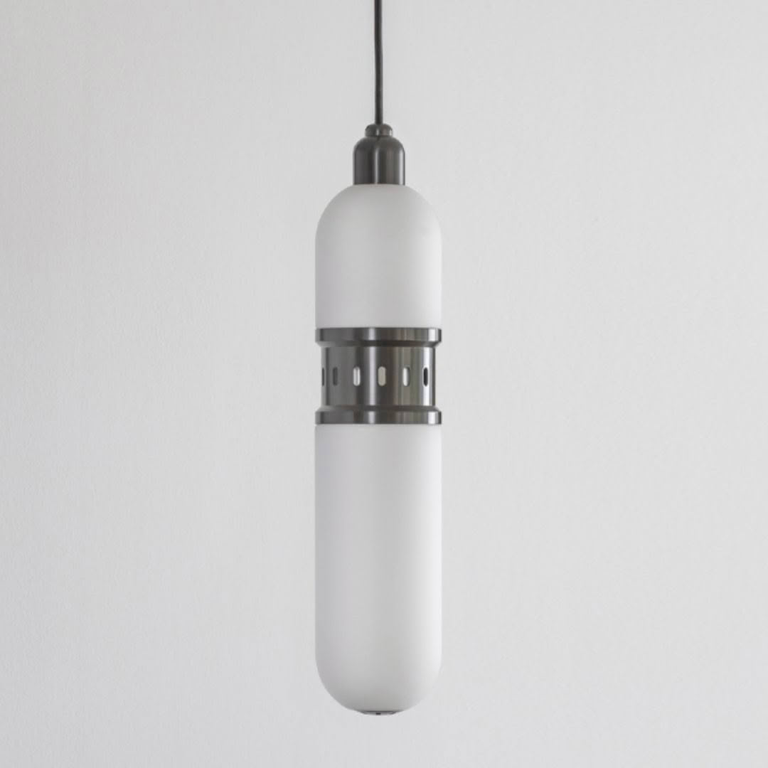 Modern white cylindrical pendant light against light wall