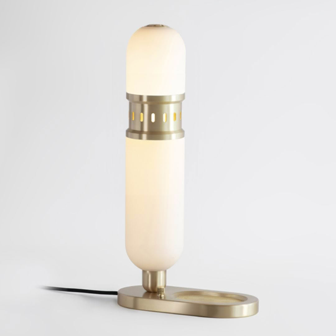 Modern gold and white table lamp illuminated