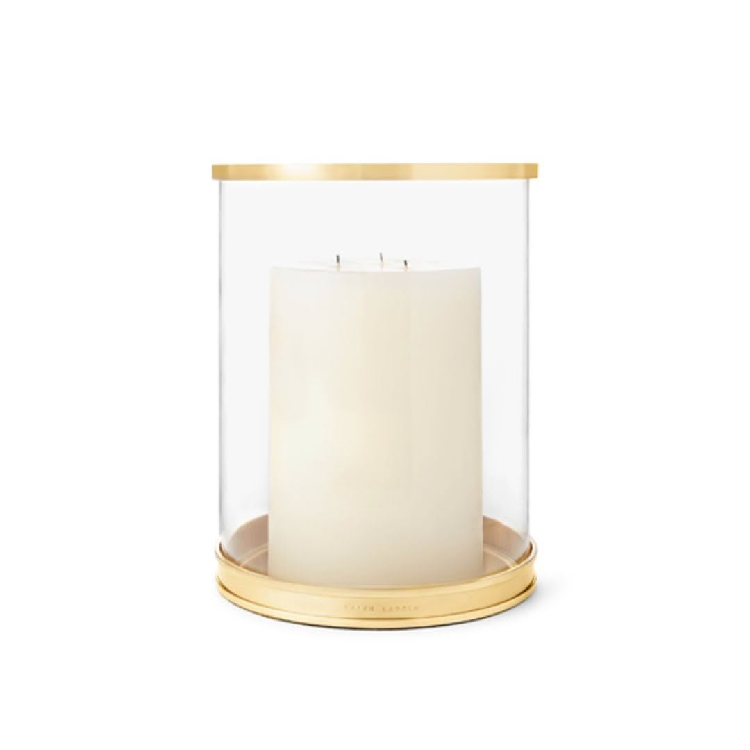 Large white candle in golden glass holder