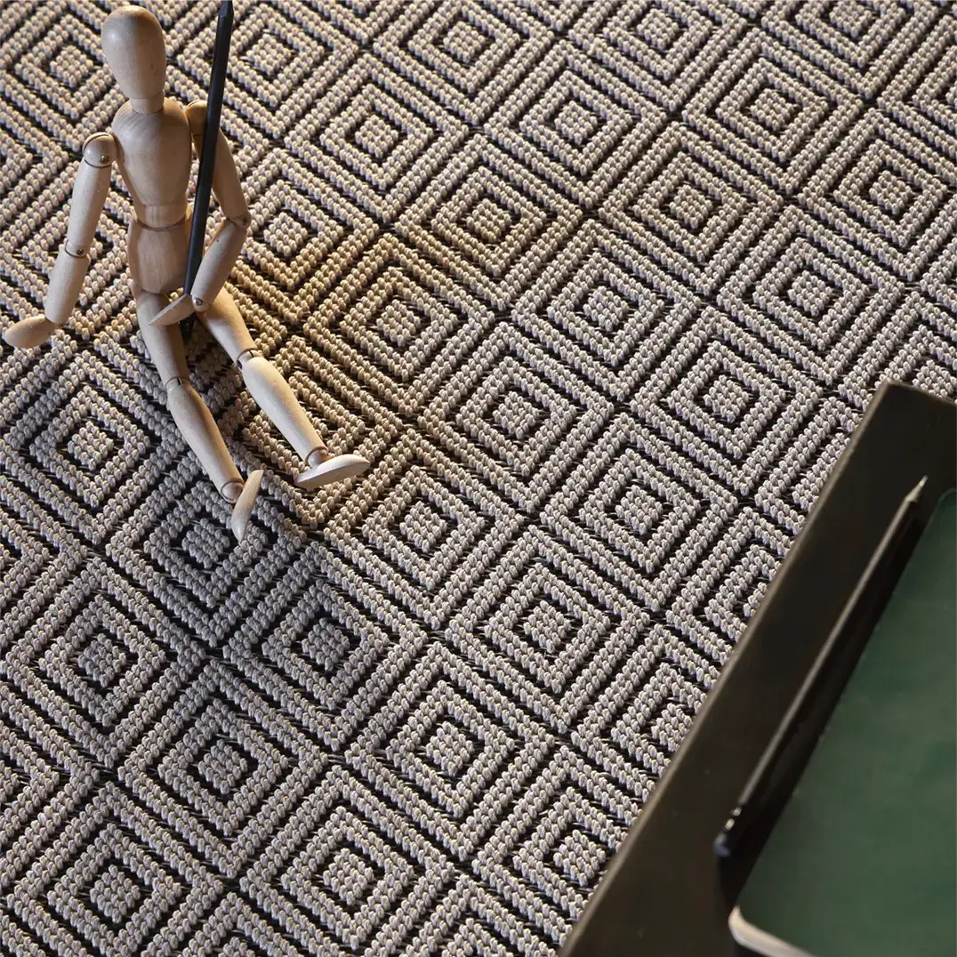 Wooden mannequin on geometric patterned carpet