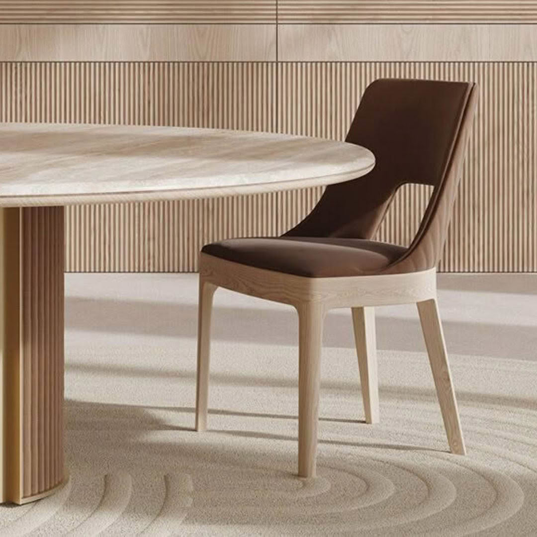 Elegant wooden dining chair beside a round marble table