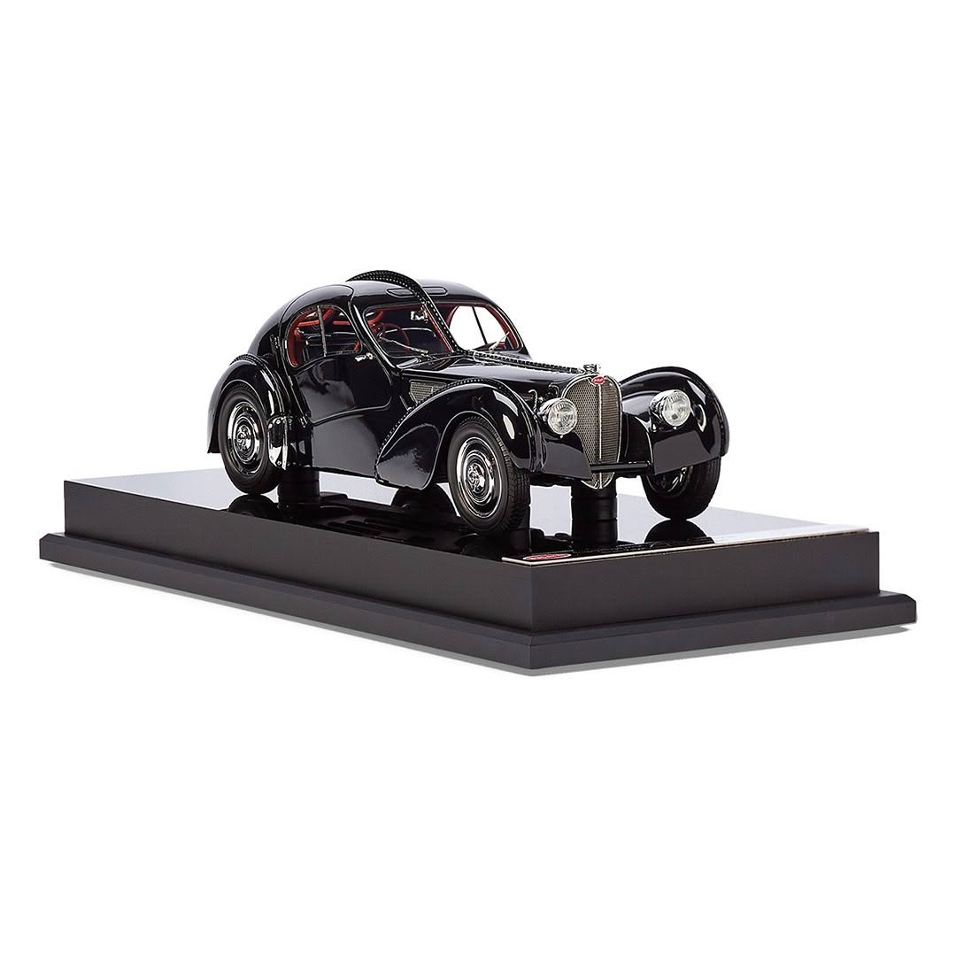 Vintage black car model on display stand