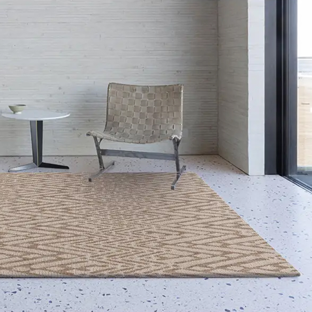 Modern chair and table on textured woven rug