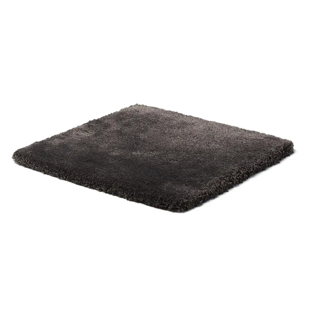 Gray shaggy area rug on white background