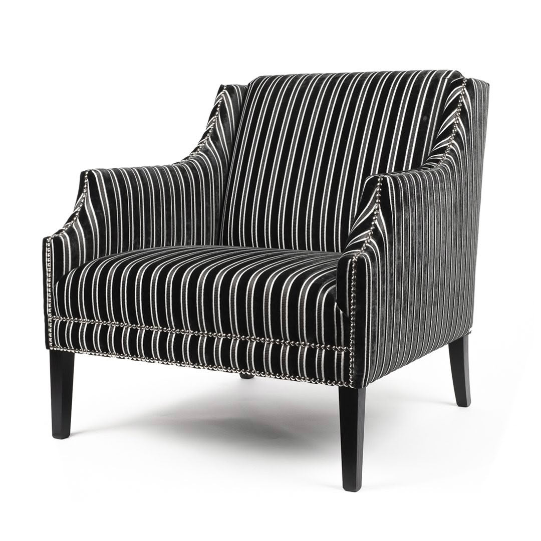 Striped black and white upholstered armchair on white background