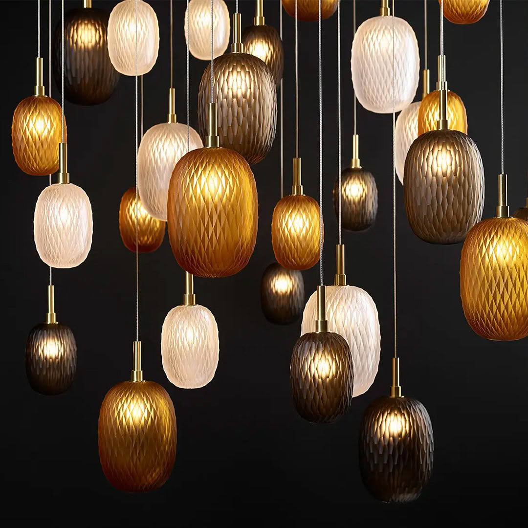 Elegant assorted hanging pendant lights on dark background