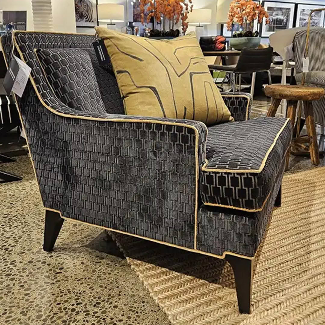 Elegant gray patterned armchair with yellow cushion