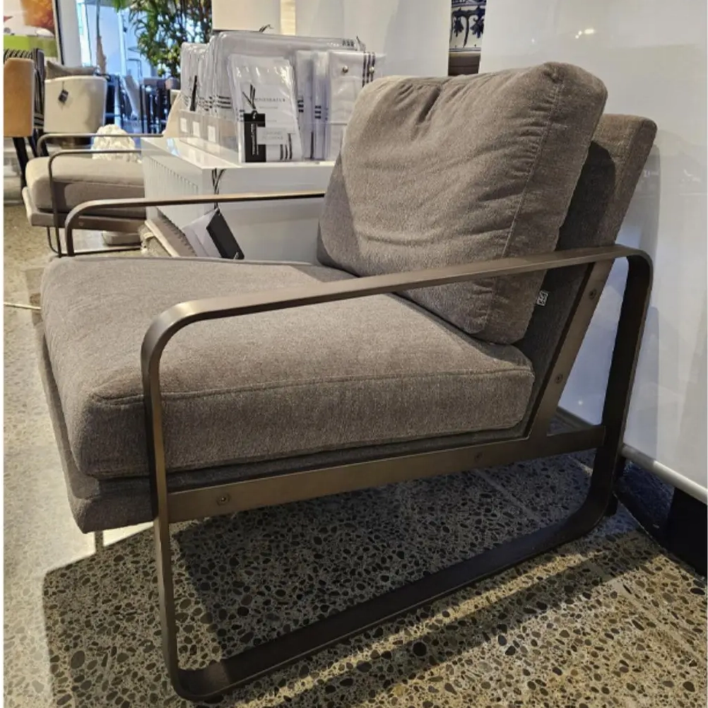 Modern gray fabric sofa with metal frame in store