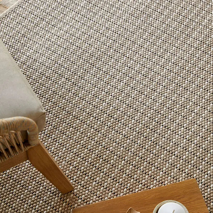 Close-up of textured beige woven rug