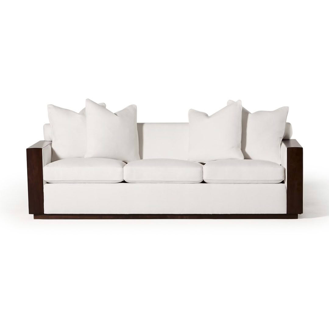 Modern white sofa with plush cushions and wooden frame