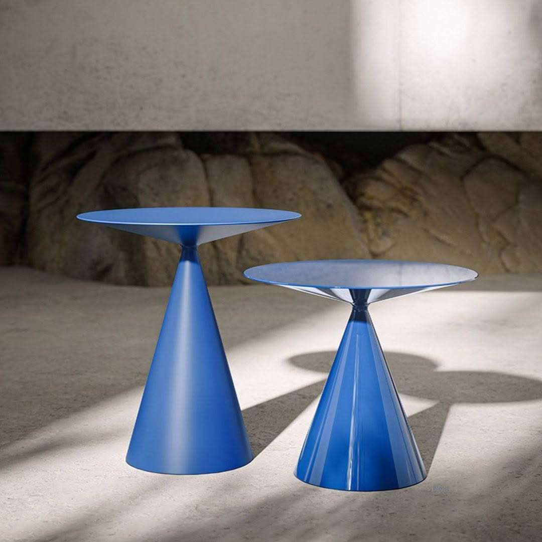 Two blue cone-shaped modern tables in minimalist setting
