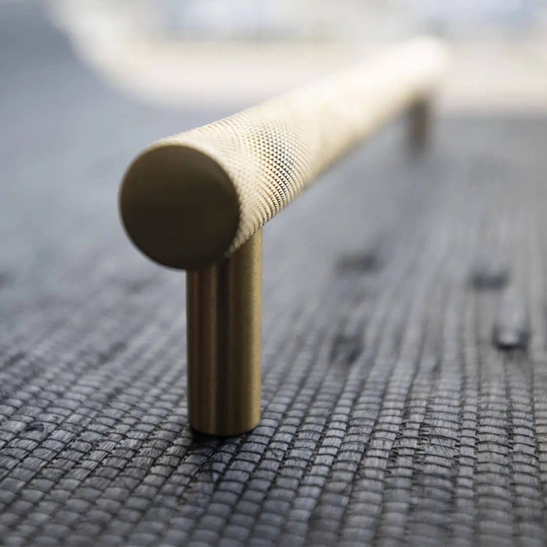 Close-up of textured metal handrail on mesh surface