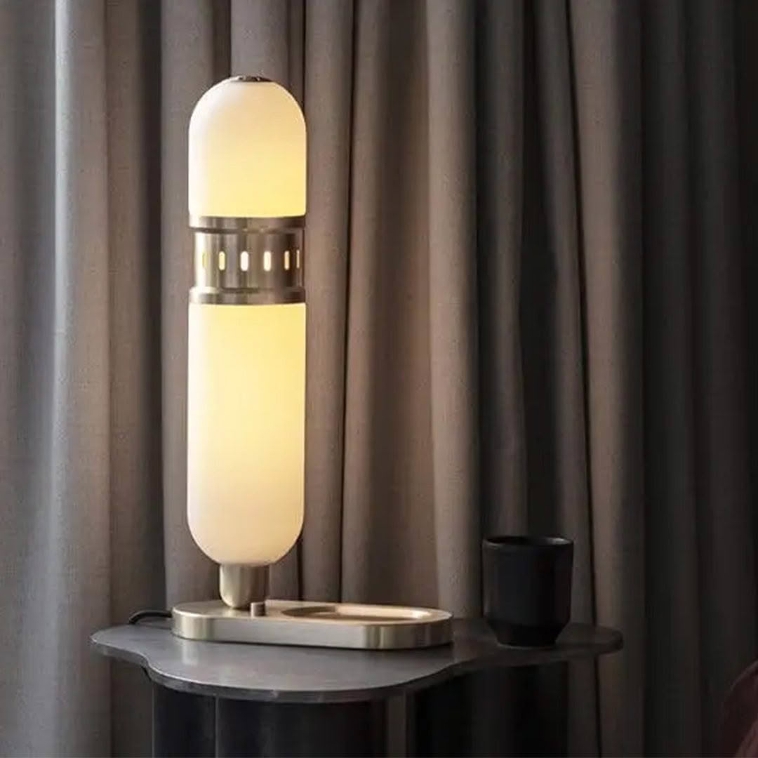 Elegant modern lamp on bedside table with curtains