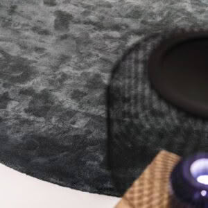 Close-up of gray textured rug with shadow